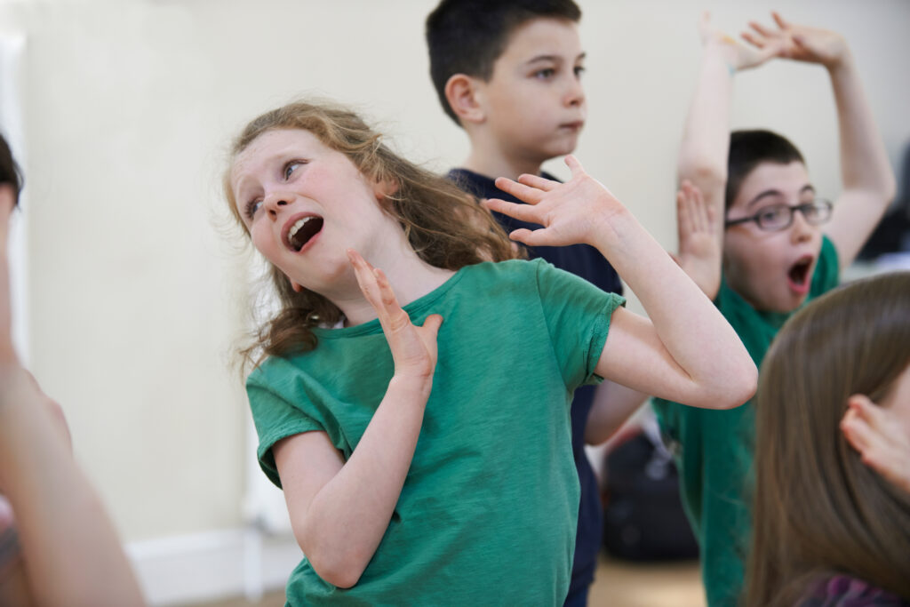 Group Of Children Enjoying Drama Class Together